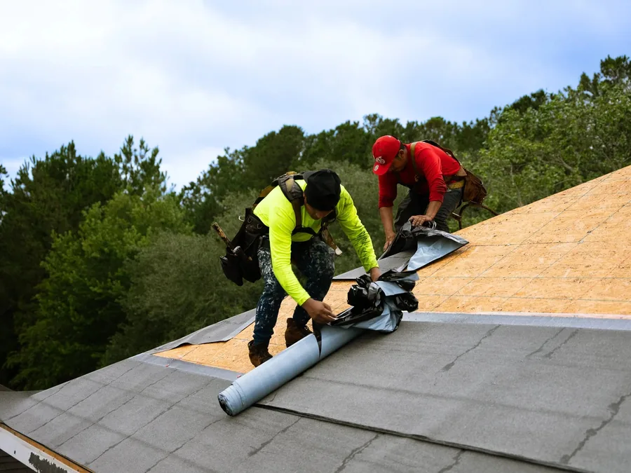 Roofer installing shingles